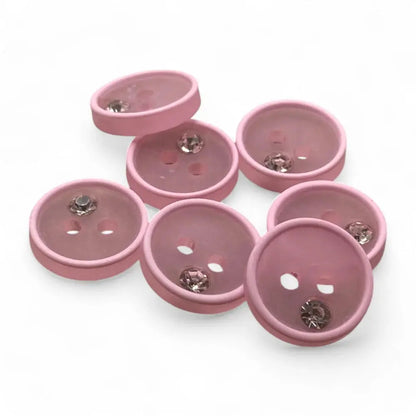 Pink decorative buttons with rhinestones.