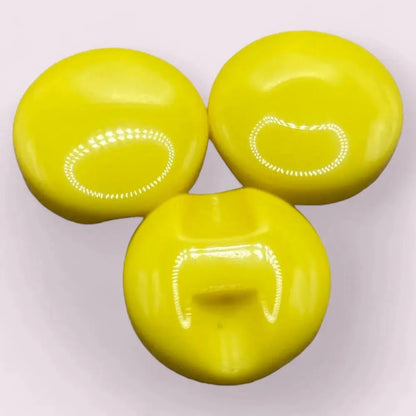Three yellow, shiny, round buttons.