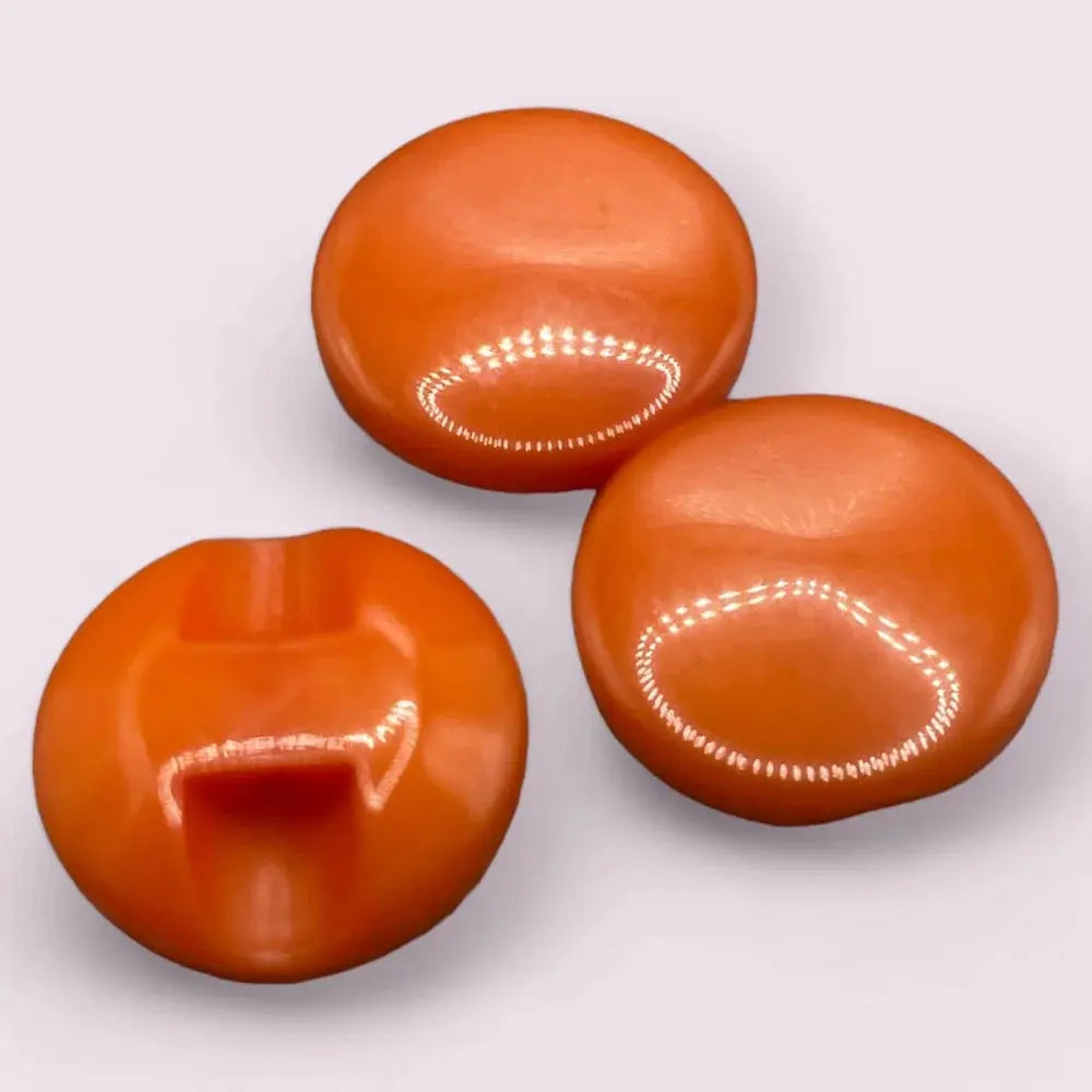 Three glossy orange buttons.