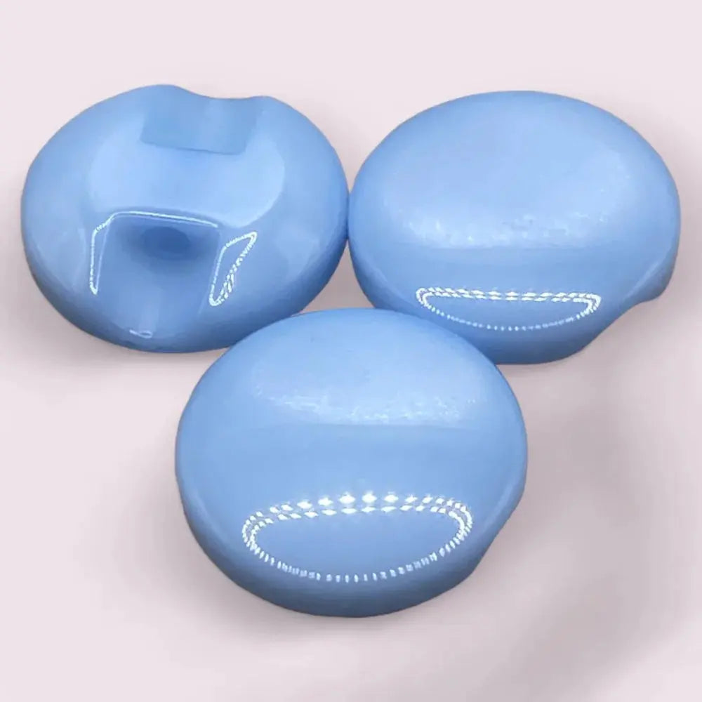 Three light blue, glossy, round buttons.