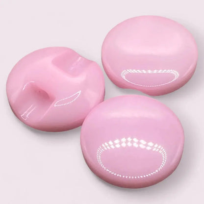 Three pink, shiny buttons.