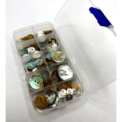 Assorted buttons in a clear plastic organizer.