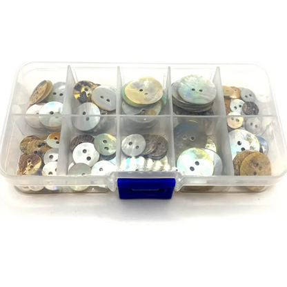 Compartmentalized box of iridescent buttons.