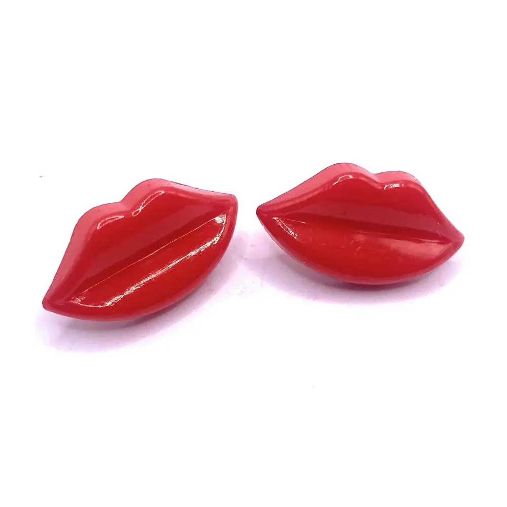 Pair of glossy red lip-shaped objects.