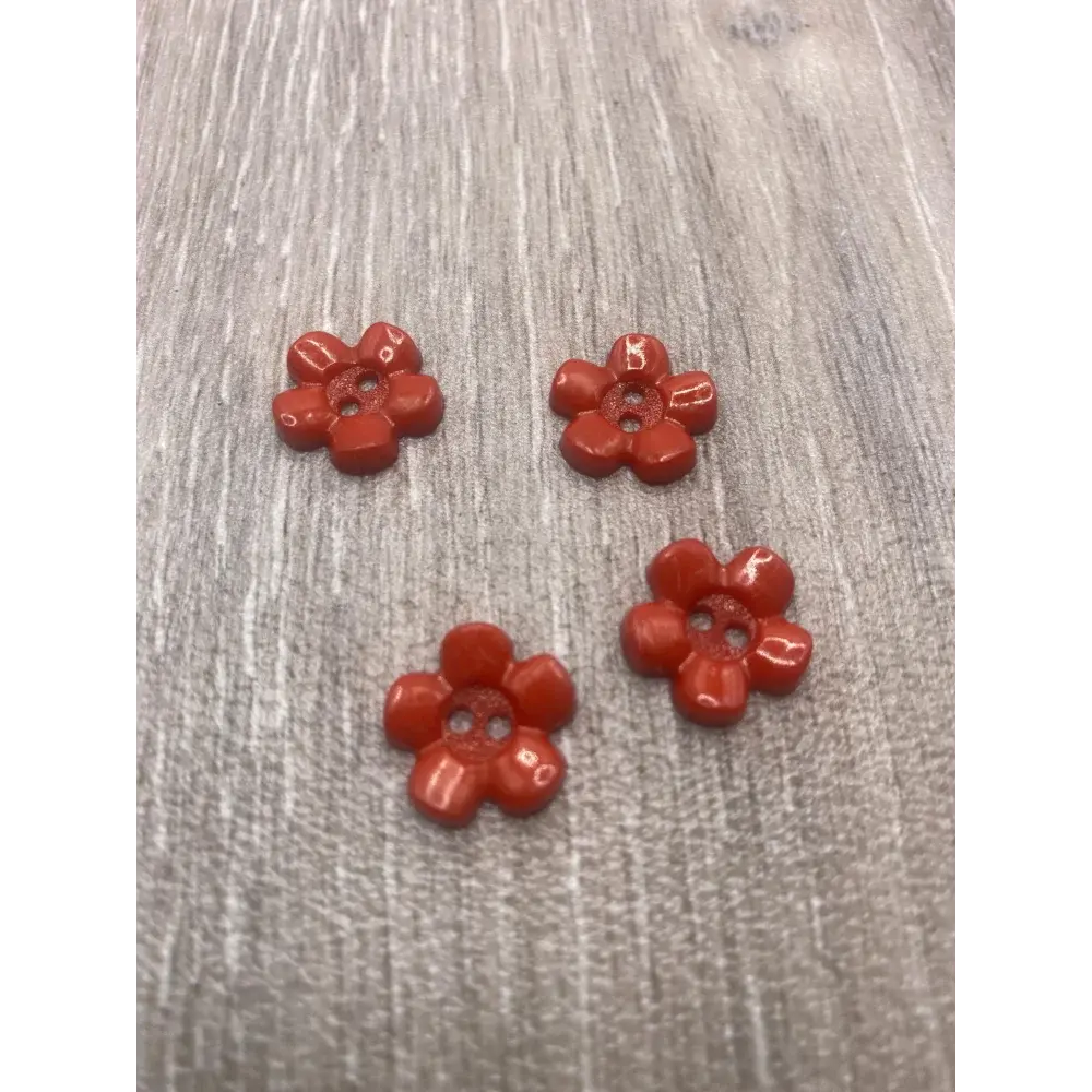 Four red flower buttons.