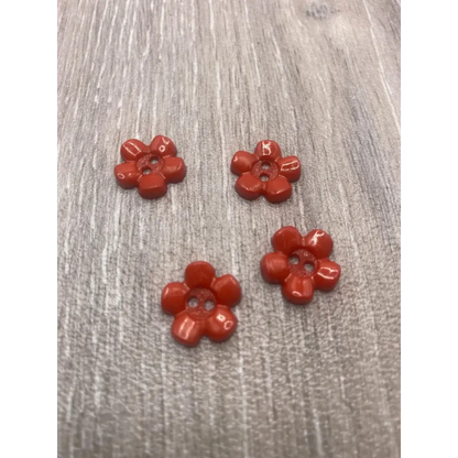 Four red flower buttons.