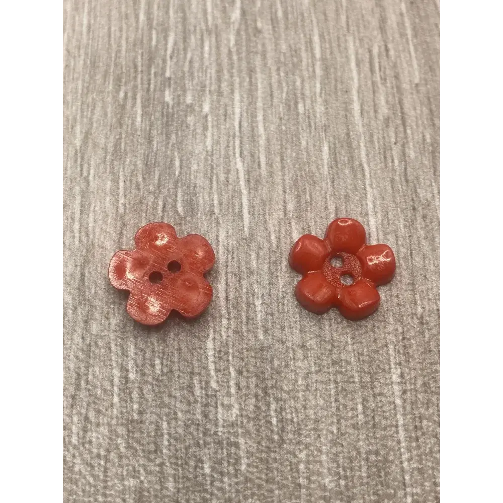 Two red flower-shaped buttons.