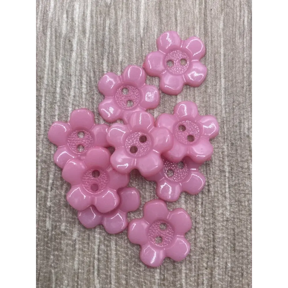 Pink flower-shaped buttons with two holes.