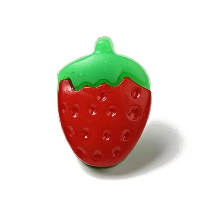 Red and green plastic strawberry.