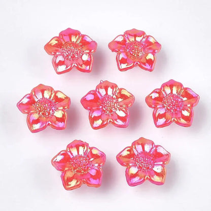 Seven iridescent pink flower beads.