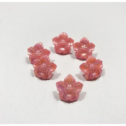 Seven pink flower-shaped beads.