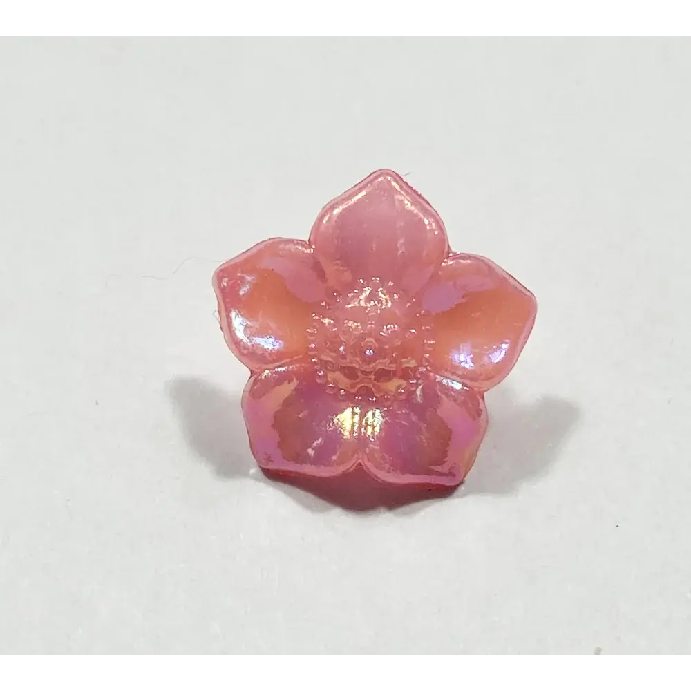 Iridescent pink flower-shaped button.