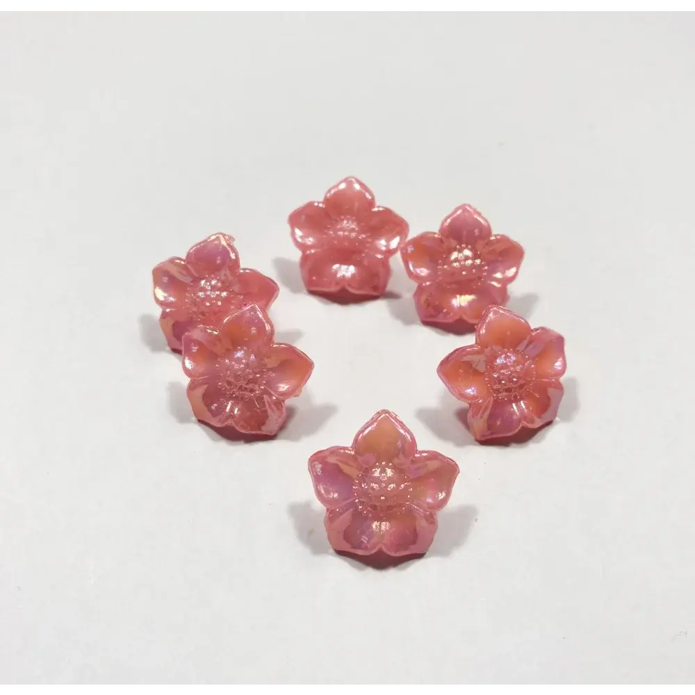 Seven pink flower-shaped beads.