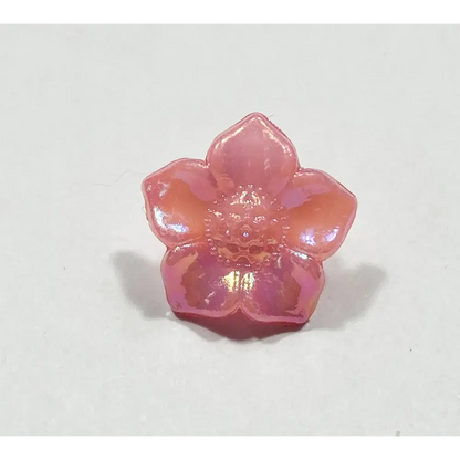 Iridescent pink flower-shaped button.