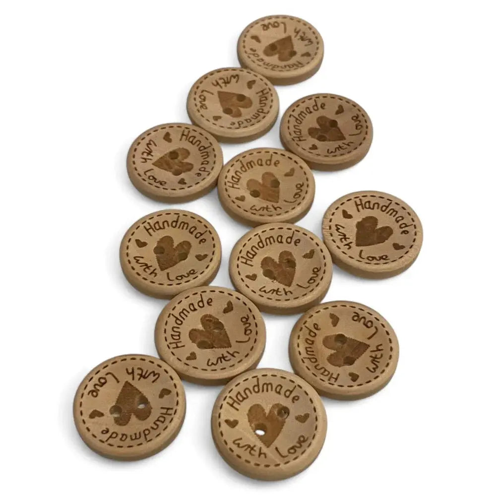 Round wooden buttons with heart and text.