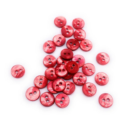 Pile of red, two-hole buttons.