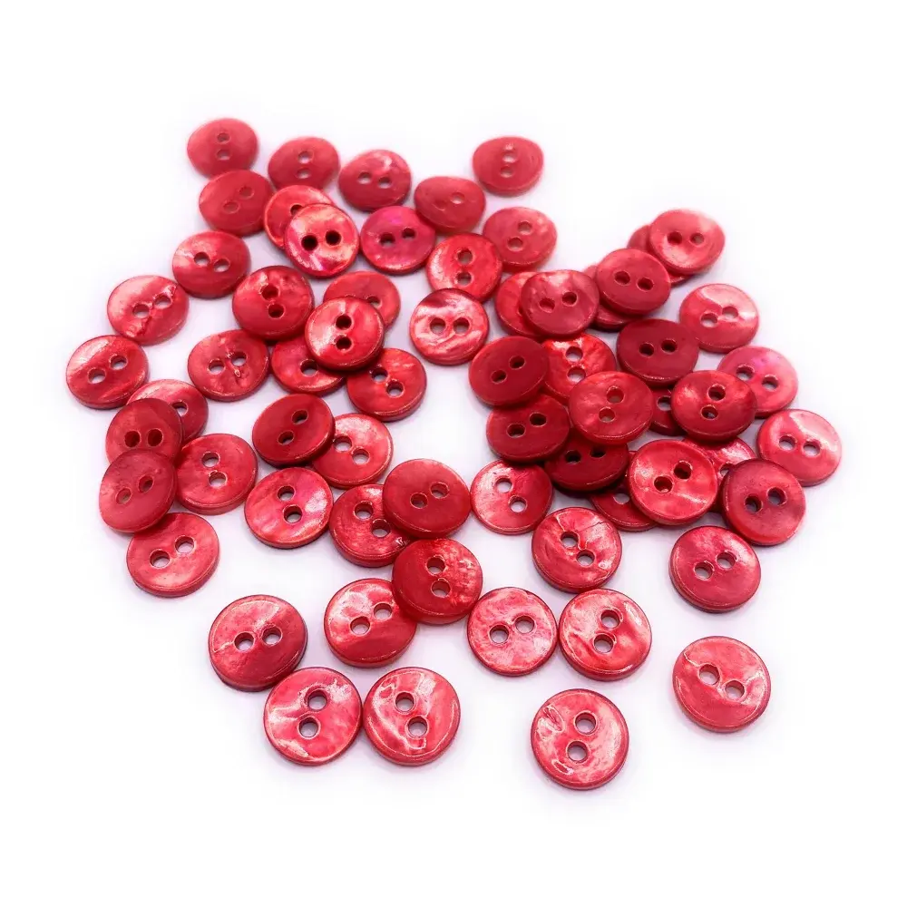 Pile of red two-hole buttons.
