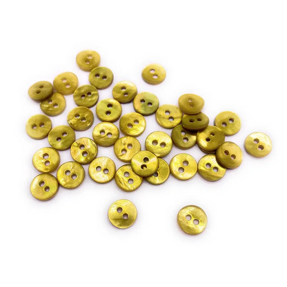 Pile of iridescent yellow buttons.