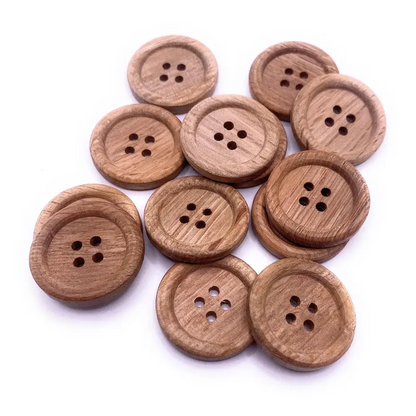 Pile of round wooden buttons.