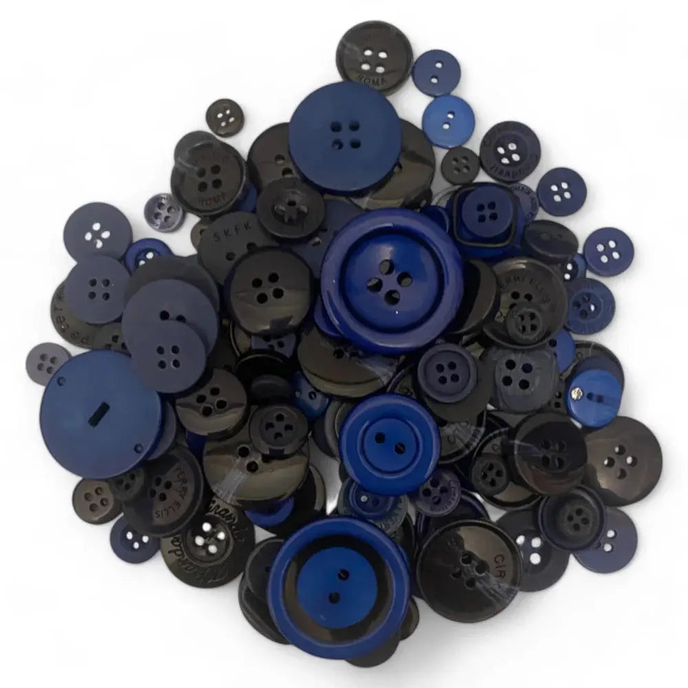 Pile of assorted blue and black buttons.