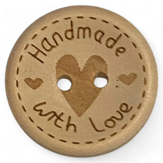 Round wooden button with heart design.