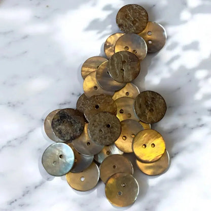 Pile of iridescent, two-holed buttons.