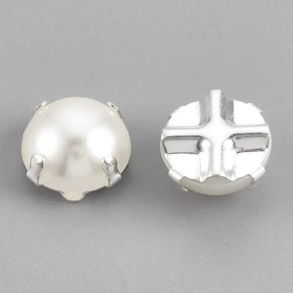 Two white pearl cabochons with silver settings.