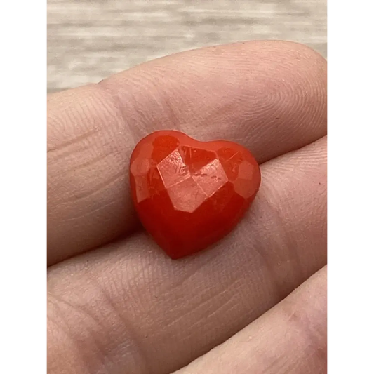 Red faceted heart-shaped gem.