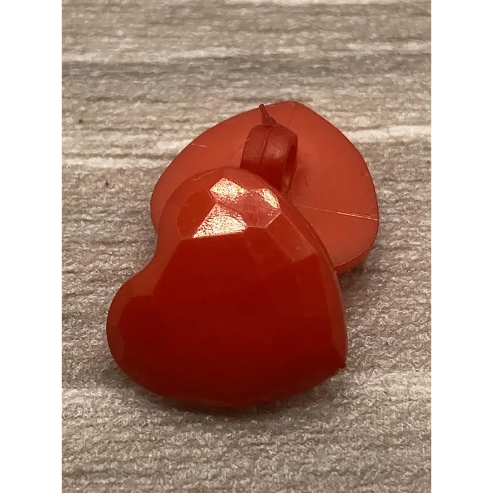 Red heart-shaped button.