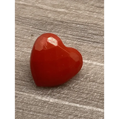 Red heart-shaped gemstone.