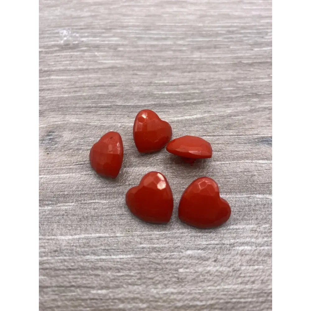 Five red heart-shaped buttons.