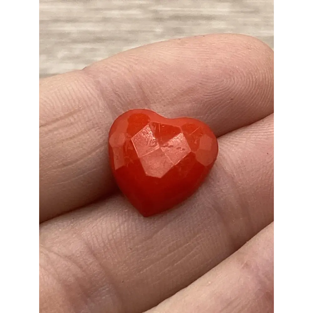 Red faceted heart-shaped gem.