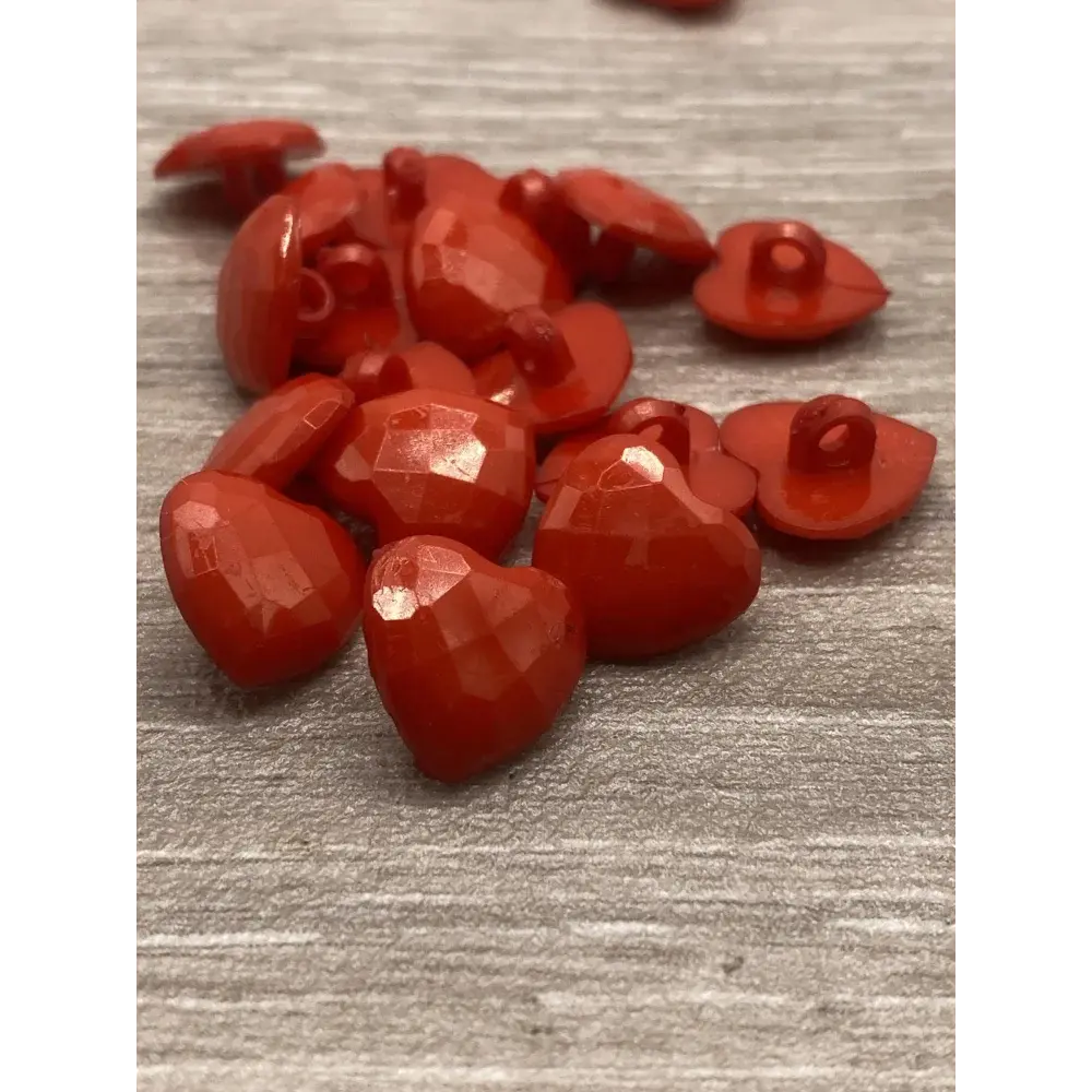 Red heart-shaped faceted buttons.