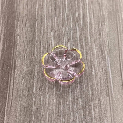 Translucent pink flower with gold trim.