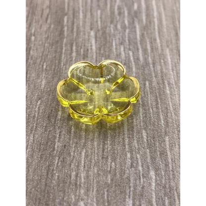 Yellow flower-shaped glass dish.