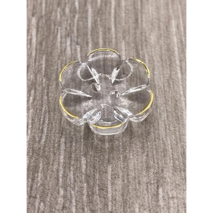 Clear glass flower-shaped dish with gold trim.