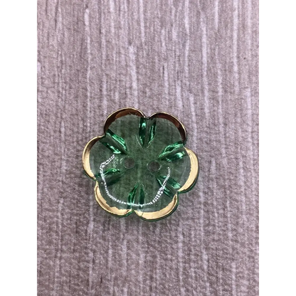 Green flower-shaped button with gold trim.