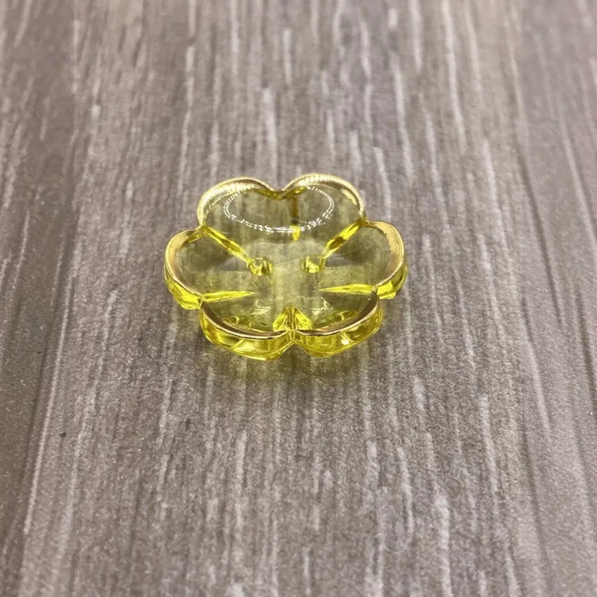Yellow flower-shaped glass dish.