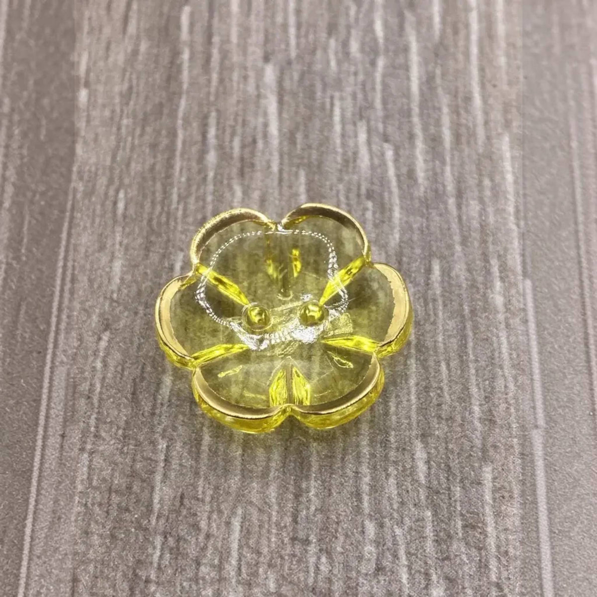 Yellow flower-shaped button.