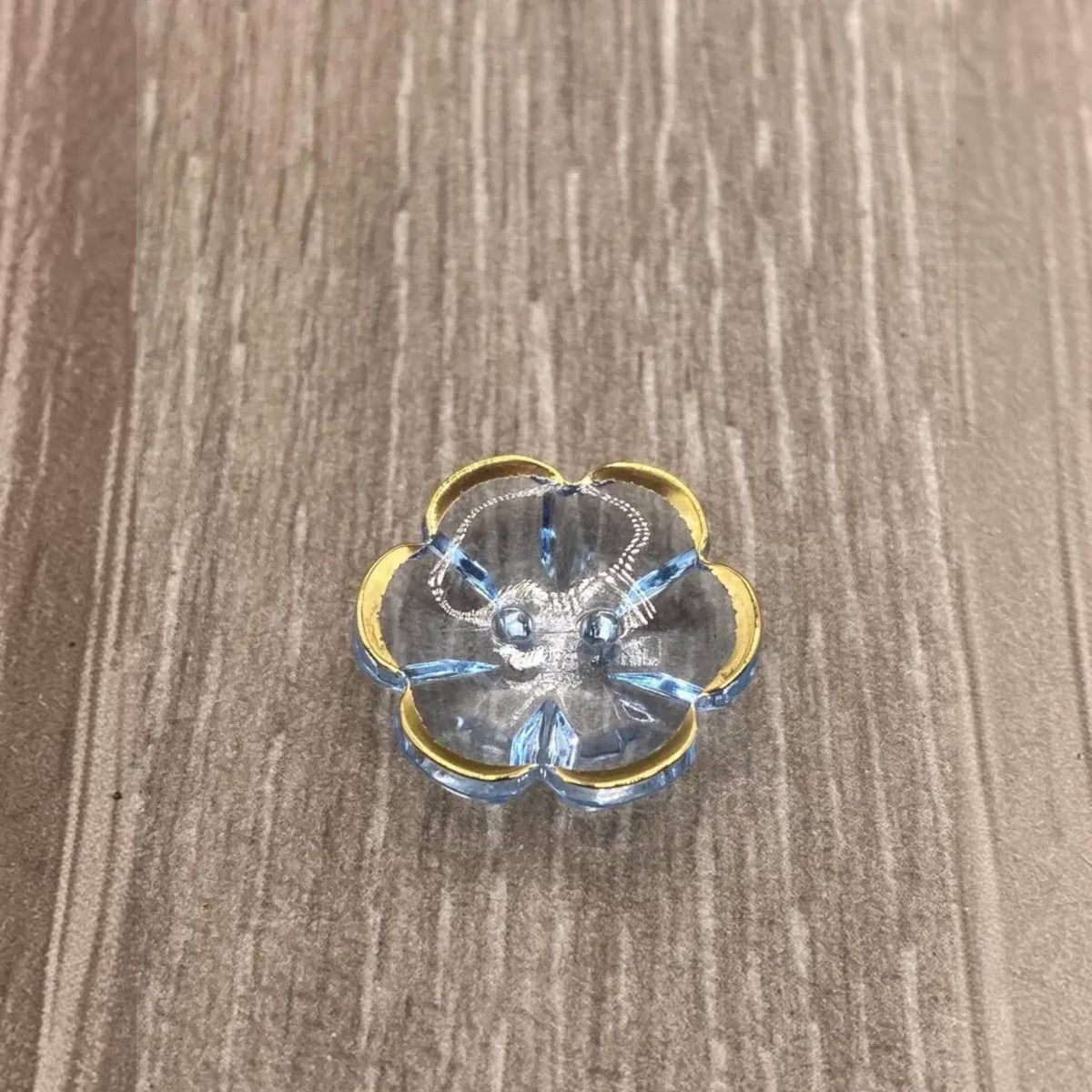 Blue glass flower trinket dish with gold trim.