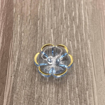 Blue glass flower trinket dish with gold trim.