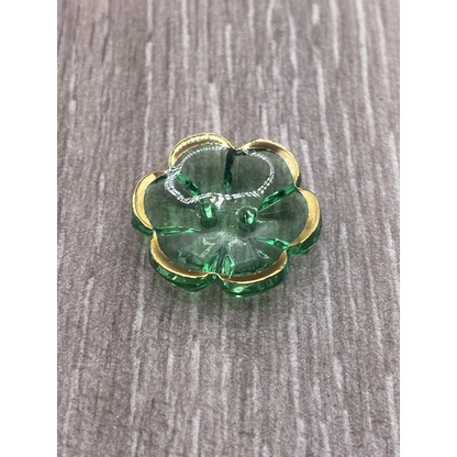 Green glass flower with gold trim.