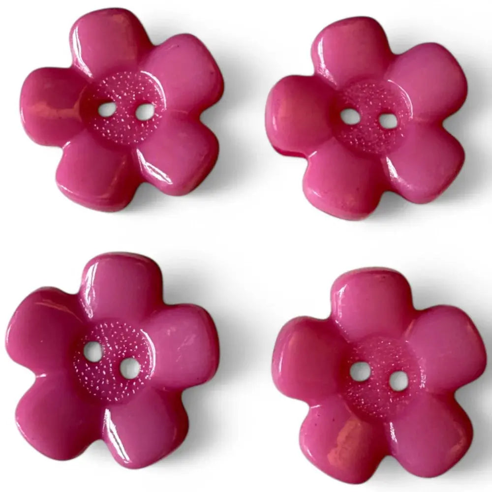 Four pink flower-shaped buttons.