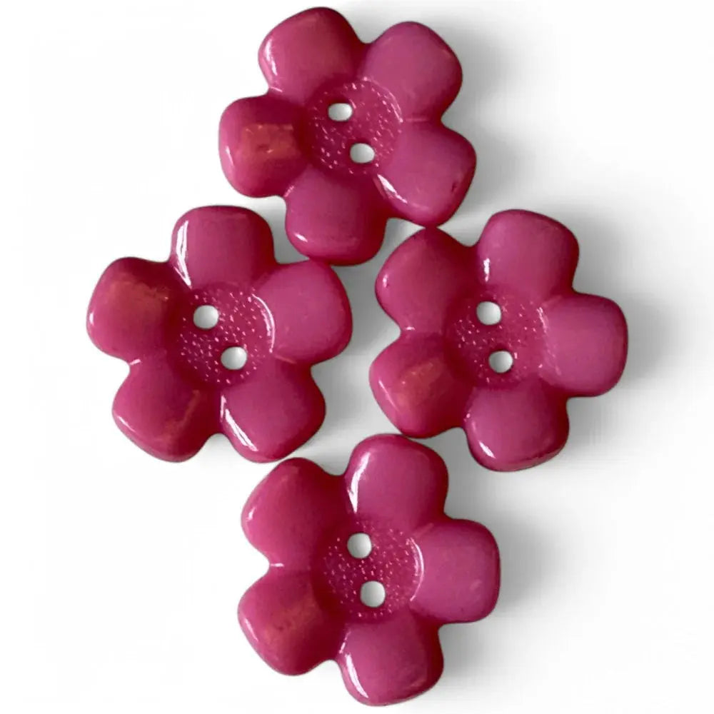 Four pink flower-shaped buttons.
