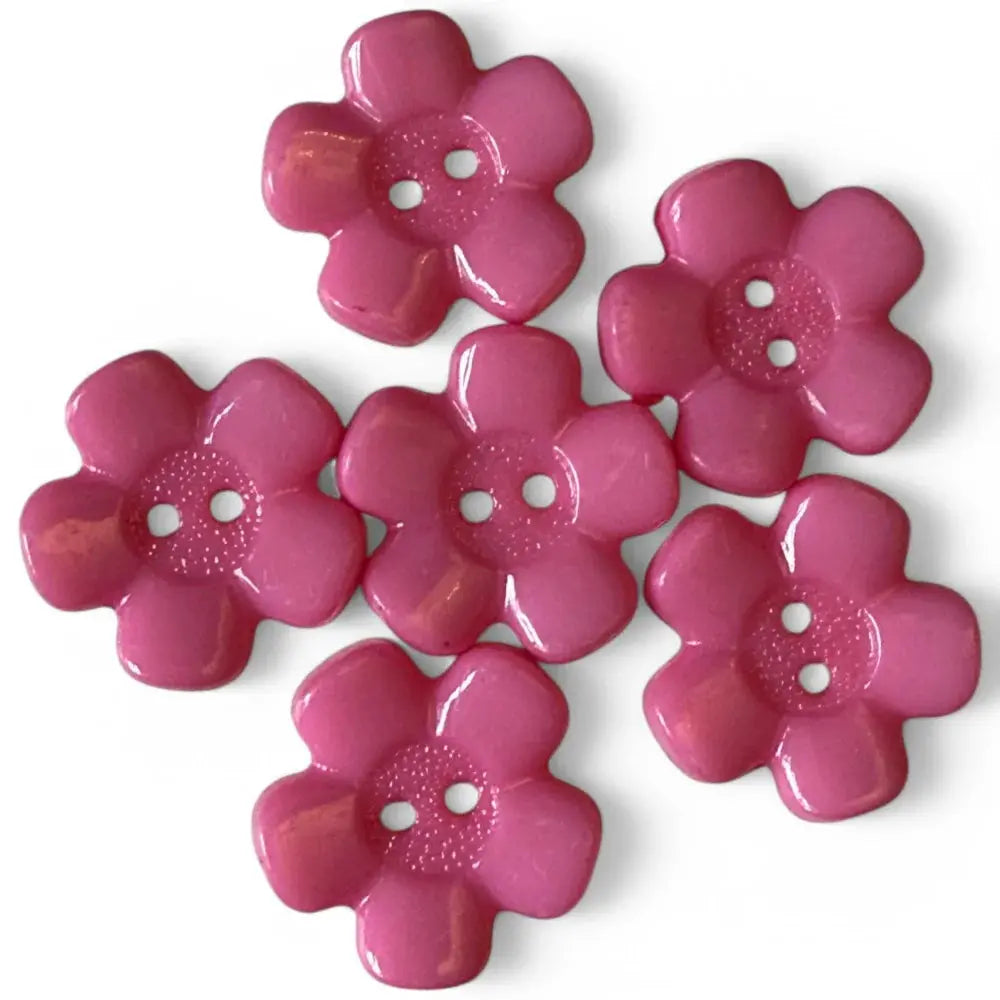 Six pink flower-shaped buttons.