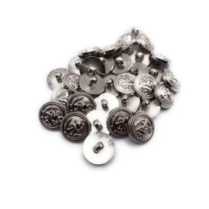 Pile of silver-colored, nautical-themed buttons.