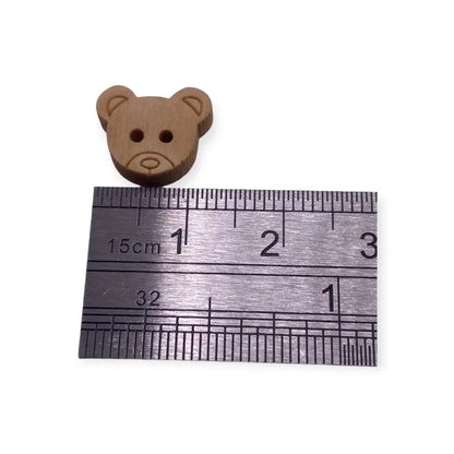 Brown teddy bear button.