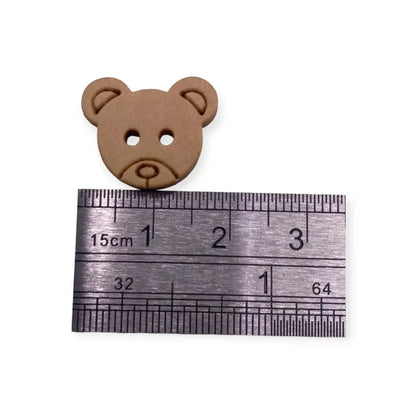 Brown teddy bear button.