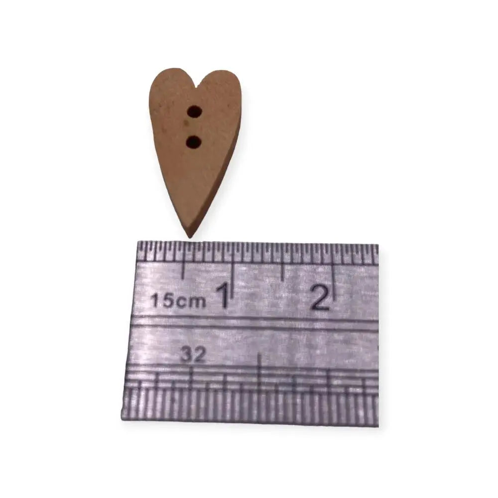 Brown heart-shaped button with two holes.