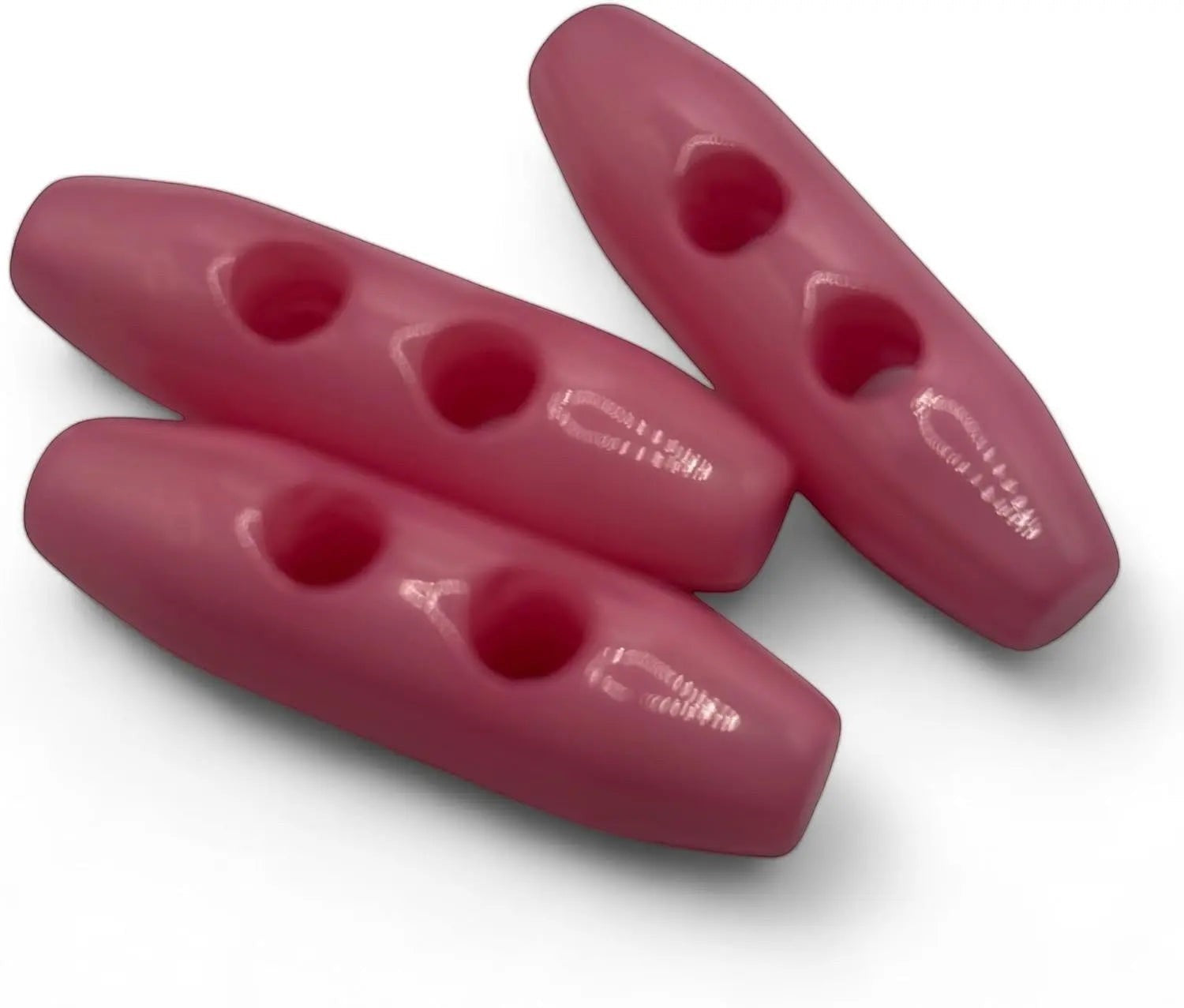 KnitForLess baby pink 38mm plastic toggle buttons with a 2-hole oval design for coats and jackets.